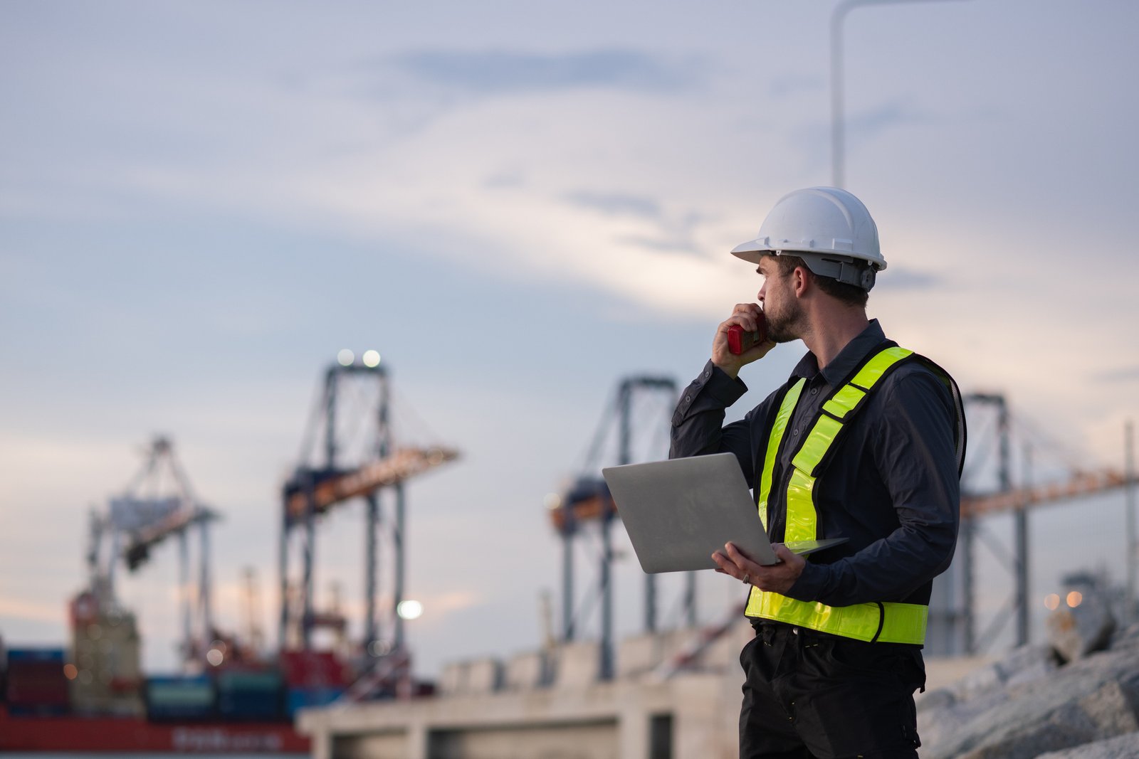Industrial engineer workers operations marine port cranes loading and unloading of cargo ships global trade and supply chain import export environment monitoring responsible global economy.